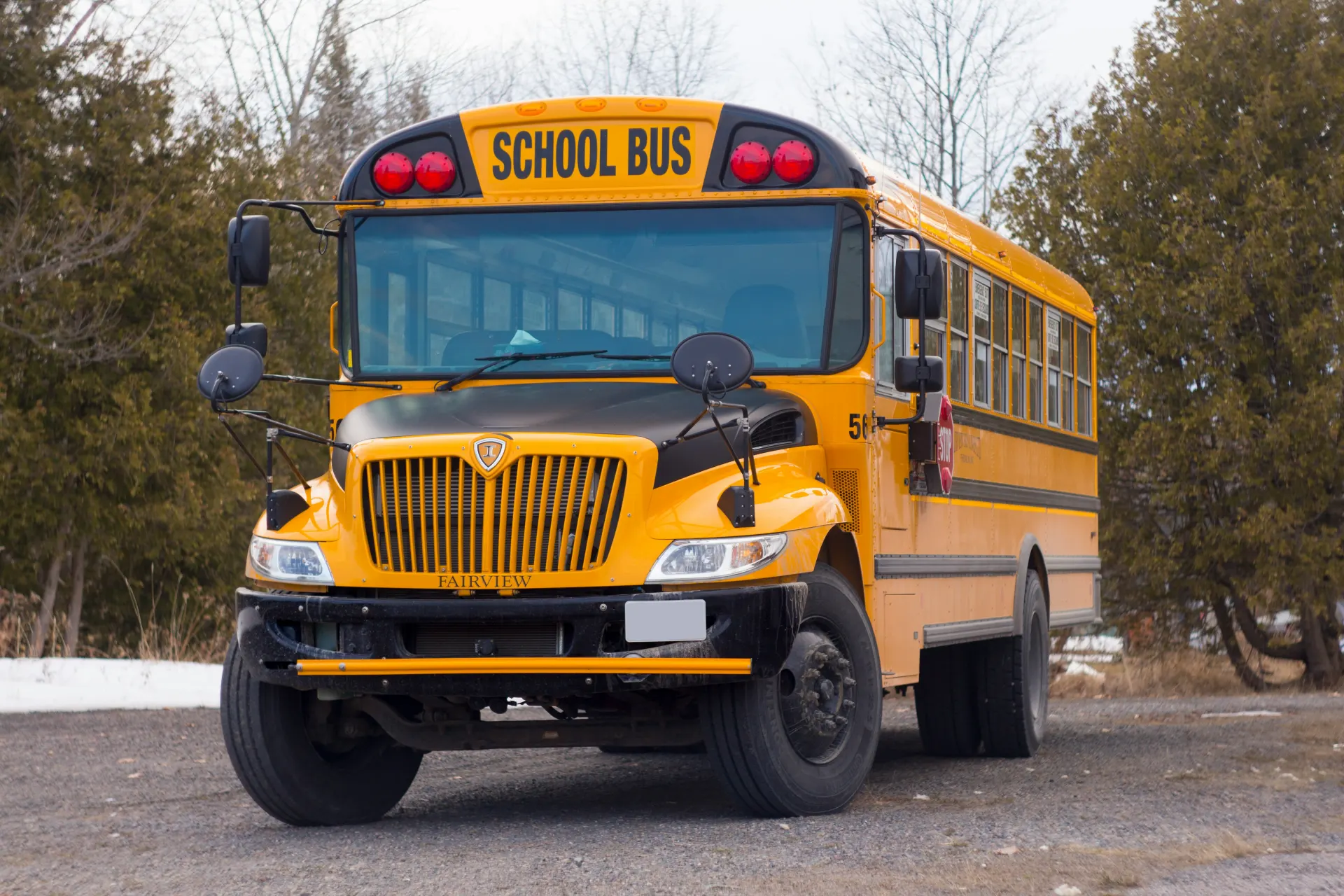 A yellow Vermont school bus, parked outdoors in winter.
